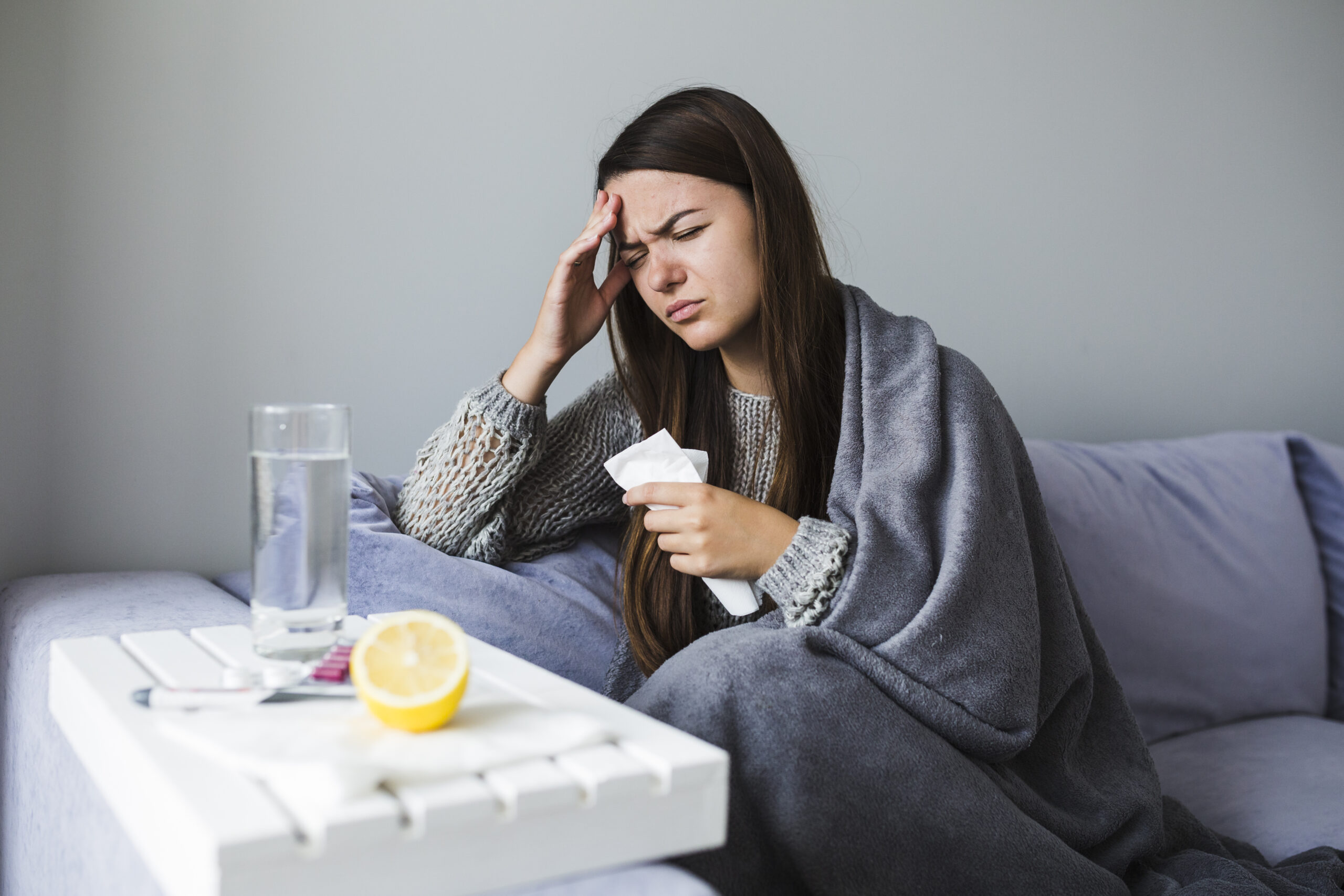 woman on couch with medication scaled